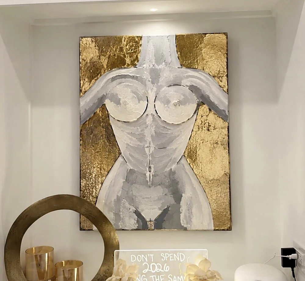 Hand-applied gold leaf across a raised surface