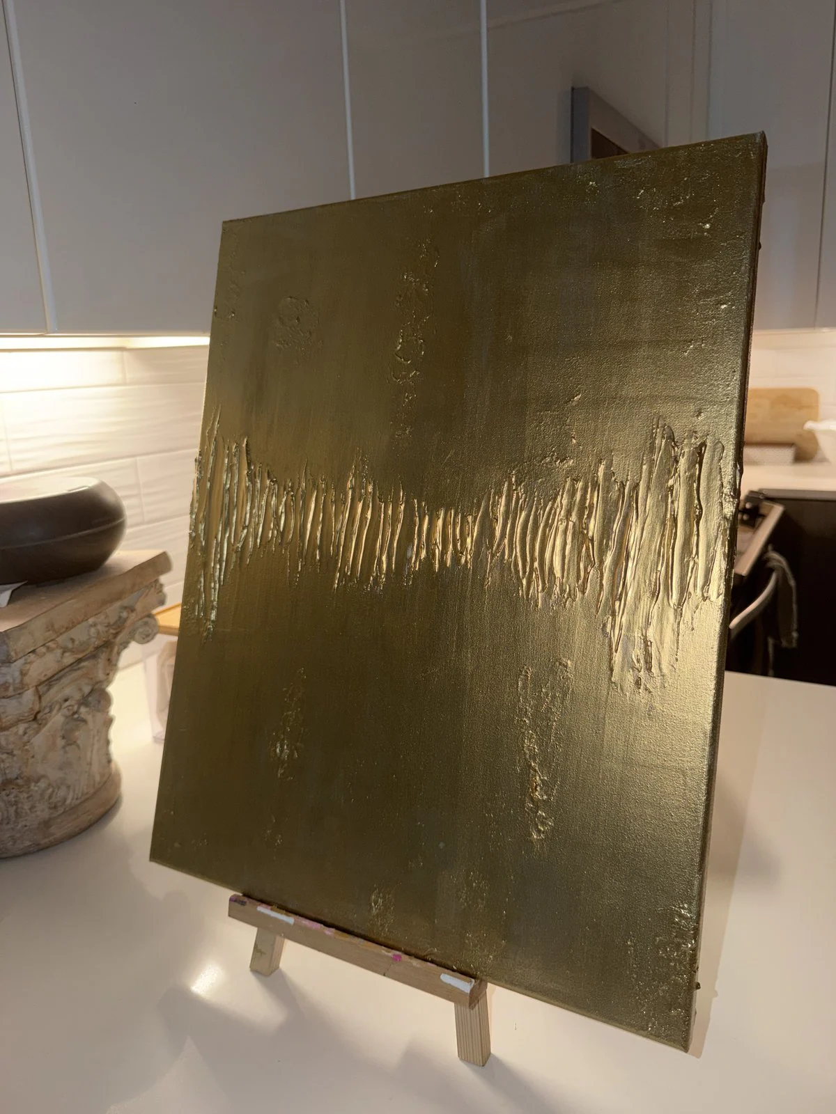 A gold canvas in progress in the studio